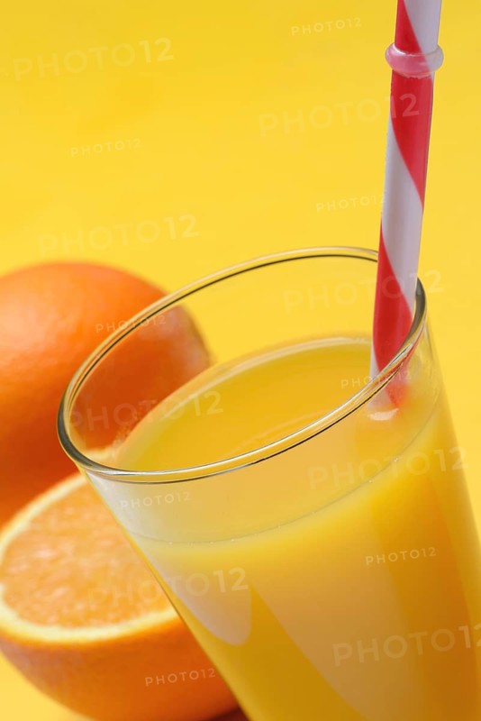 Orange juice in glass and orange, straw