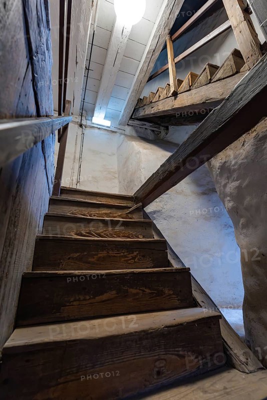 Wooden staircase in an old building with rustic atmosphere and lighting from above, Prison Museum, Der Lange, Calw, Black Forest, Germany