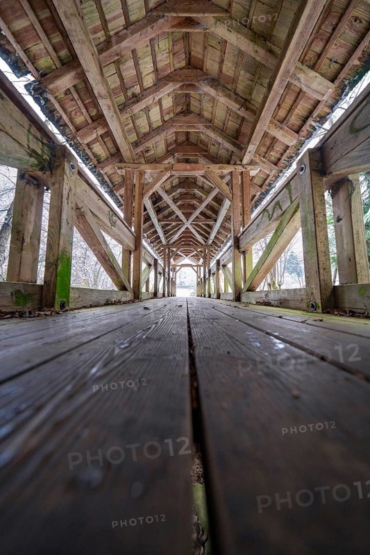 Interior view of a snow-covered wooden bridge with symmetrical structures, Kälberbrücke, Enzklösterle, district of Calw, Black Forest, Germany