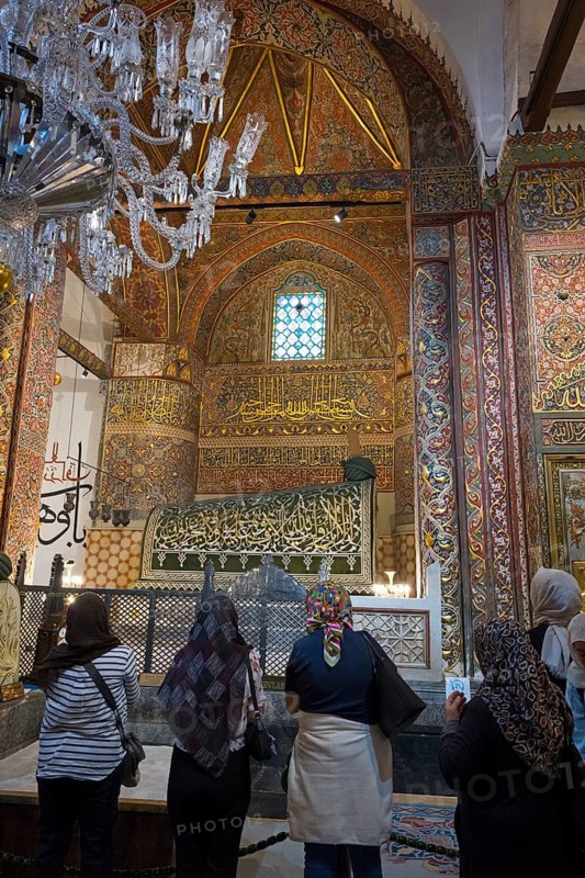 Visitors look at a richly decorated, historic room with calligraphy and ornaments, tomb of the famous Persian poet and Sufi mystic Jalal ad-Din Rumi, known as Mevlana, Mevlana Museum, Mevlana Museum, Mausoleum of Mevlânâ Jalal ad-Din Rumi, Konya, Central Anatolia, Turkey
