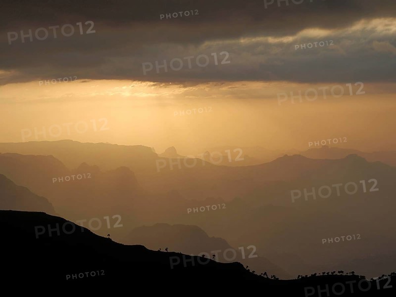 Peaceful sunset over vast mountain silhouettes and dramatic lighting, Simien National Park, Ethiopia