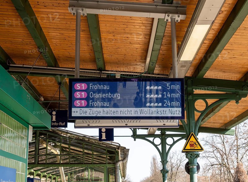 S-Bahn platform with historic structures and the display board for the train connections at Lichterfelde West station, Berlin, Germany
