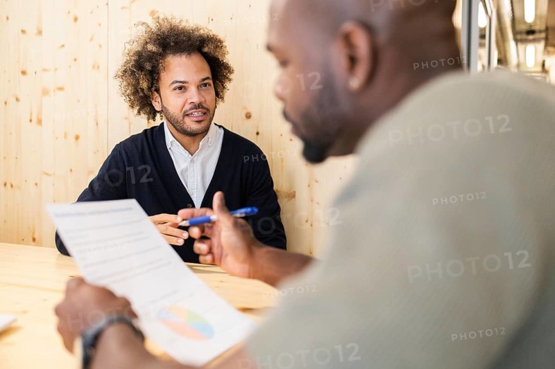 Professionals engage in a productive meeting at a coworking space in Barcelona, fostering collaboration and innovation. The modern environment enhances teamwork and creativity