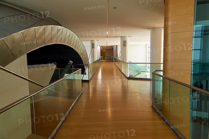 Long modern corridor with glass railings and wooden floor, flooded with light, Patras Archaeological Museum, Patras, Peloponnese, Greece