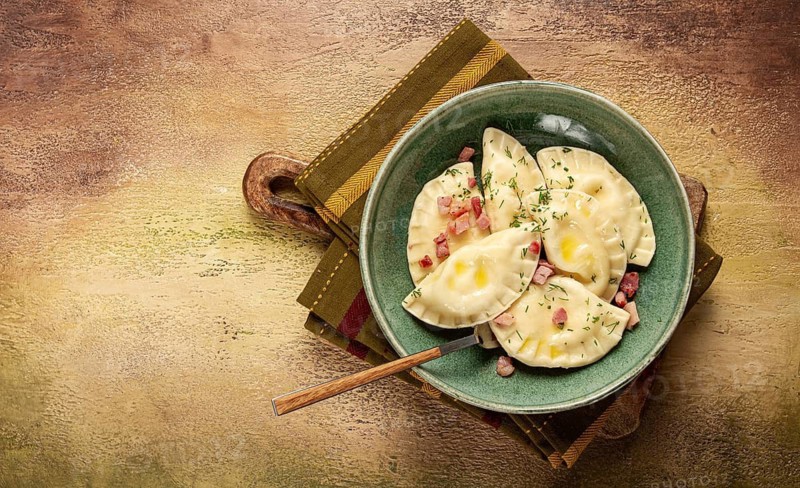 Dumplings, with fried prosciutto, a traditional dish of Polish cuisine, dumplings, top view, close-up, without people