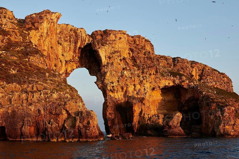 Stone bridge in dramatic sunrise light over the sea, morning light, Tsichli Babas islet, Navarino Bay, Pylos, Peloponnese, Greece
