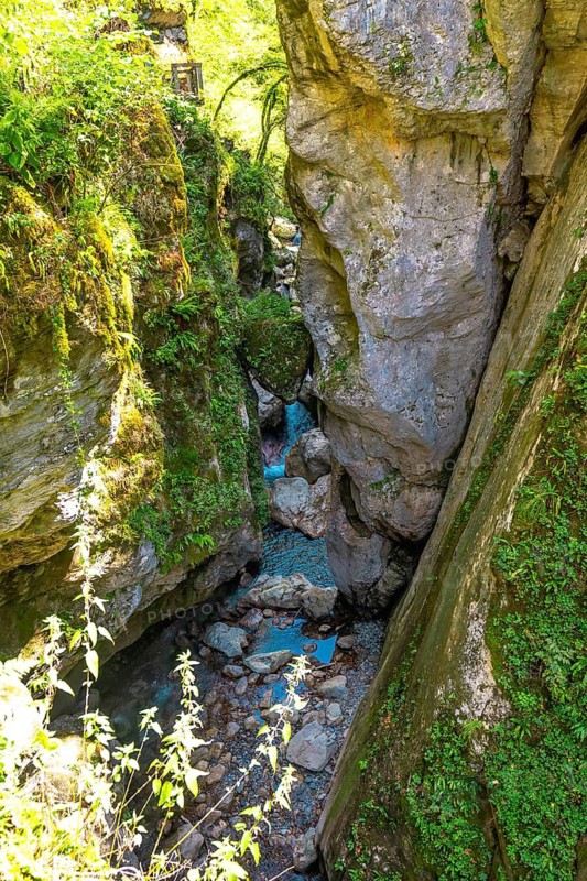 Turquoise water flowing through tolmin gorges in slovenia, creating a picturesque natural landscape