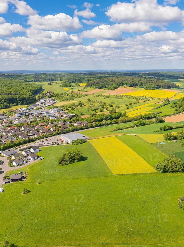 Spacious landscape with village and fields under a blue sky with clouds, Gechingen, Black Forest, Germany