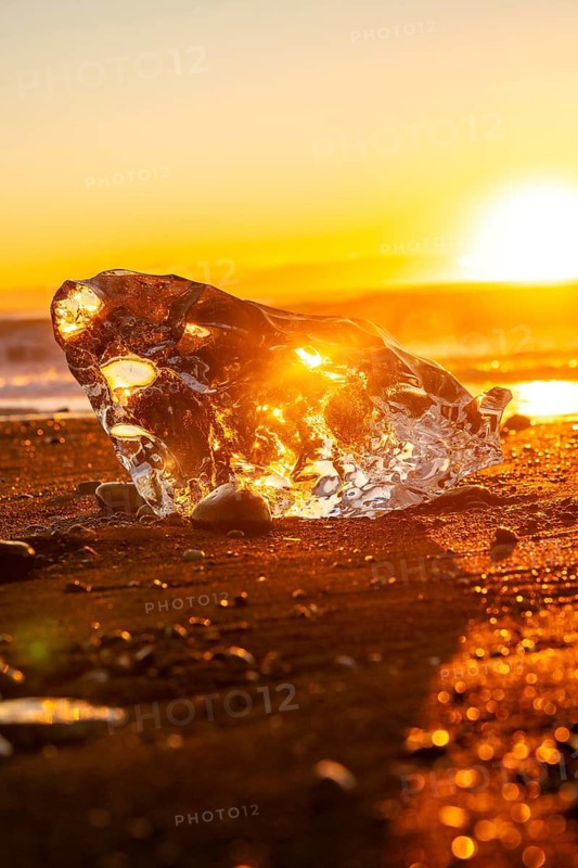 Beautiful sunrise with ice on Diamond Beach next to Jokulsarlon in winter in Iceland