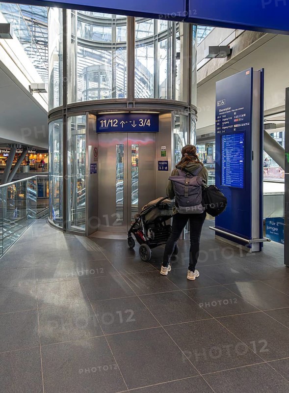 Everyday scenes, travelers and railway employees as well as the interior design, signs, signposts and the DB travel center, in and at Berlin Central Station, Germany