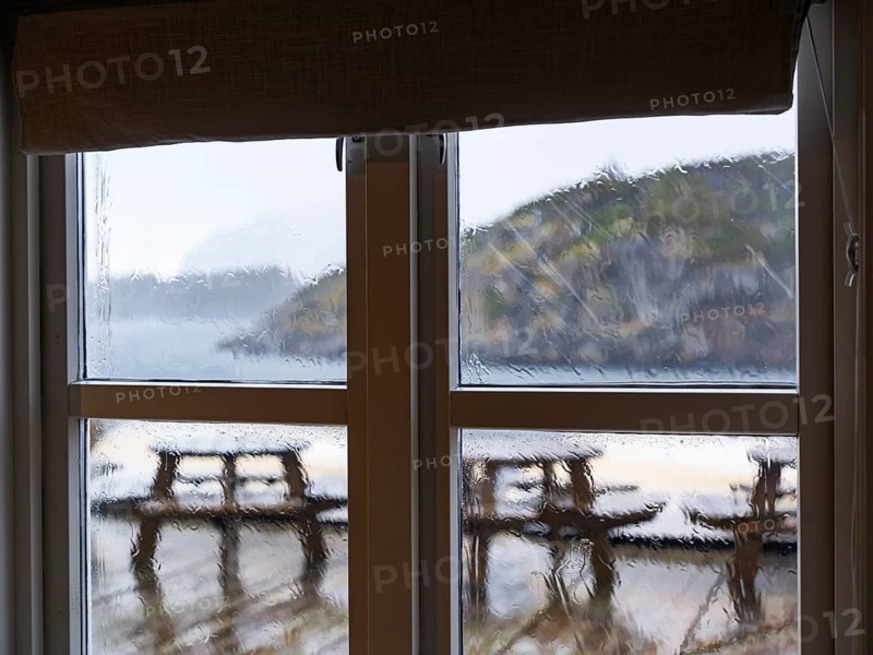View of heavy rain through a window pane, Kabelvåg, Lofoten, Norway