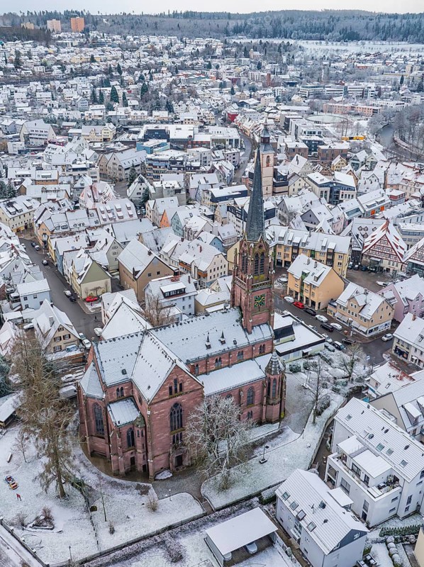 Snow-covered town with a church in the centre and snow-covered roofs, Nagold, Black Forest, Germany