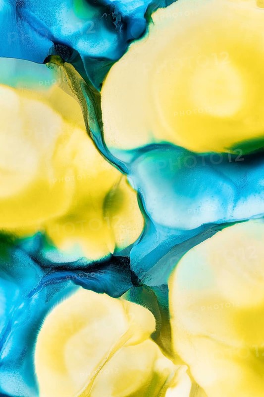 Vivid abstract art featuring flowing inks in shades of blue, teal, and yellow, creating a mesmerizing liquid blend