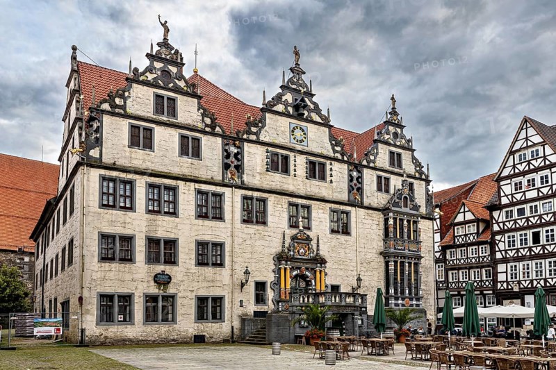 Historic square with monumental buildings and half-timbered houses under a cloud cover, The historic town hall of Hannoversch Münden in Lower Saxony