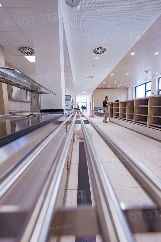 Modern food delivery in a canteen with stainless steel surfaces and floor tiles, surrounded by an open kitchen area, cafeteria, new Calw hospital, Germany