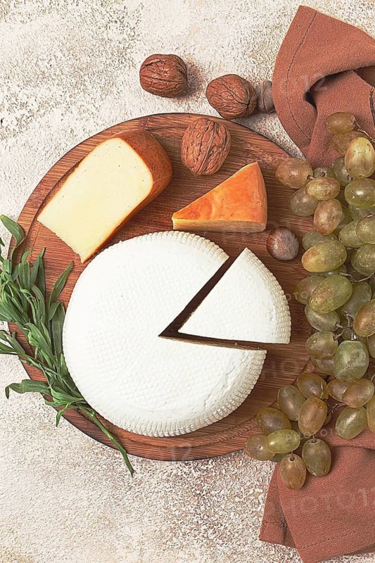 Georgian cheese, Imeretian and smoked suluguni, grapes, nuts, on a cutting board, Georgian cuisine, no people