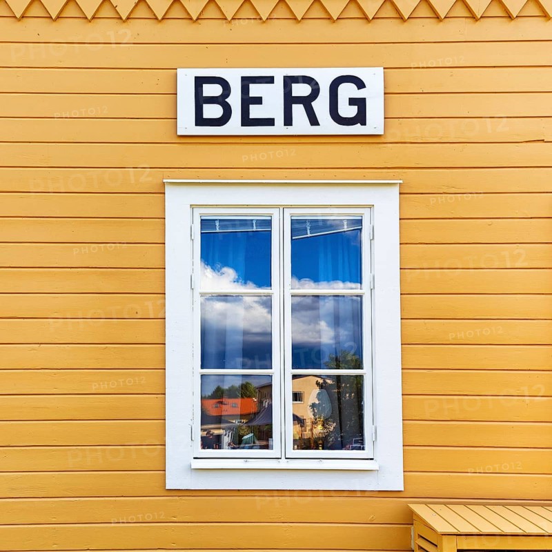 Facade detail with window, yellow wooden house, lock keeper's house, sign with inscription, lock staircase near mountain, Göta Canal, Östergötland, Sweden