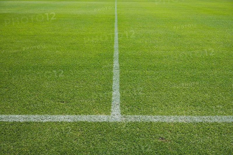 White line on the grass at soccer playing fieldin Lubin, Poland