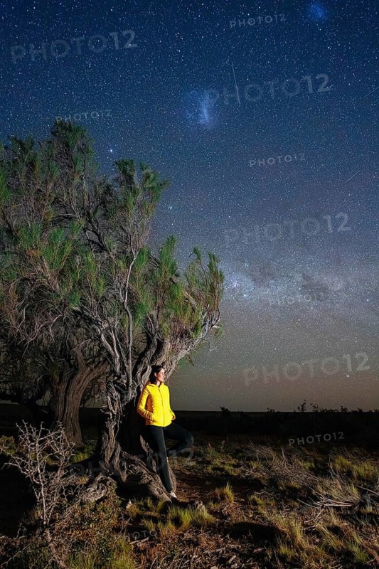 Young woman marvels at the stars of the Milky Way, Tres Cerros, Santa Cruz, Argentina