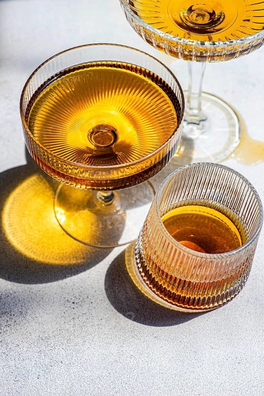 Georgian amber wine shines in crystal glasses, capturing the essence of traditional wine making. The rich color and vibrant texture highlight its unique character and elegance