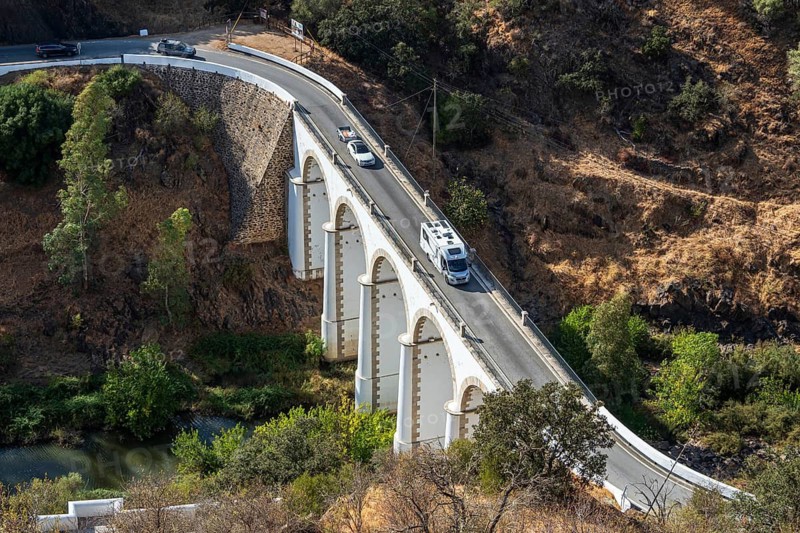 Campervan on bridge Ponte de Mertola, crossing river Guadiana, village Mertola, Portugal