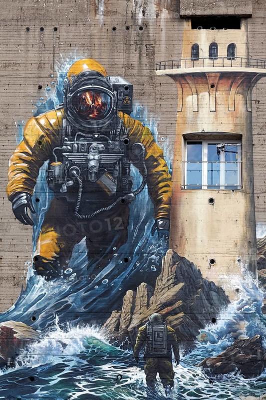 Astronaut standing in surf, mural on the subject of climate change on a bunker, by street art artist duo Tubuku, Krefeld, North Rhine-Westphalia, Germany