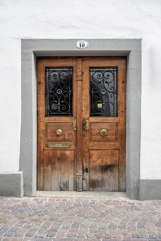 An old wooden door with decorative metal ornaments and a stone door frame in the historic old town of Constance, traditional craftsmanship, district of Constance, Baden-Württemberg, Germany