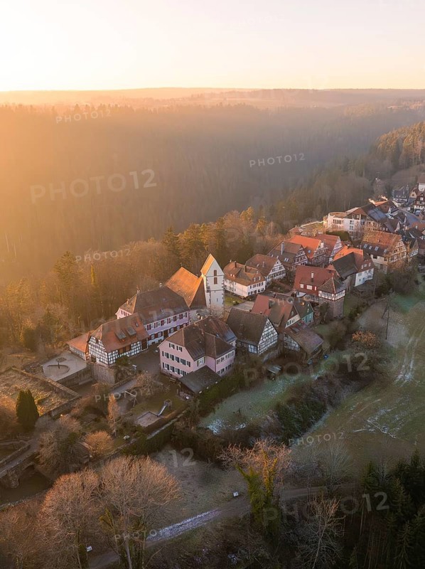 Village with half-timbered houses in a hilly and wooded landscape in the morning light, Zavelstein, district of Calw, Black Forest, Germany
