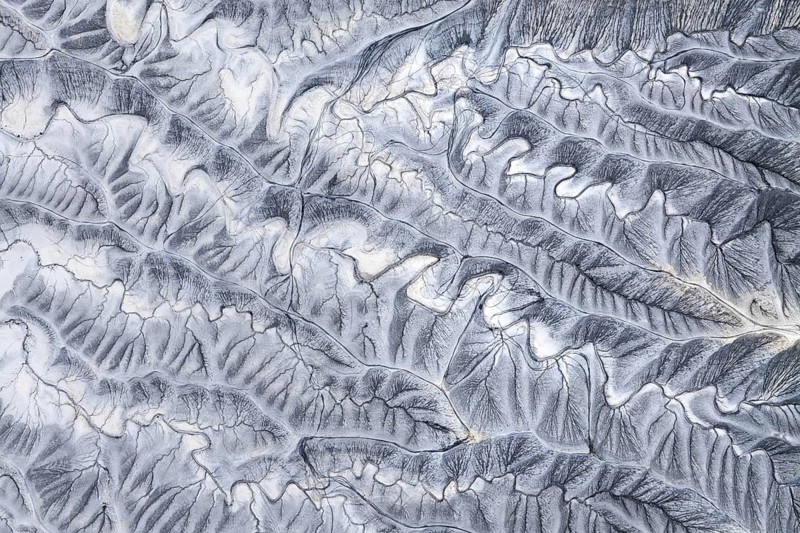 Captivating aerial photograph of the textured landscape of Moonscape Overlook in Utah, showcasing intricate patterns and natural erosion