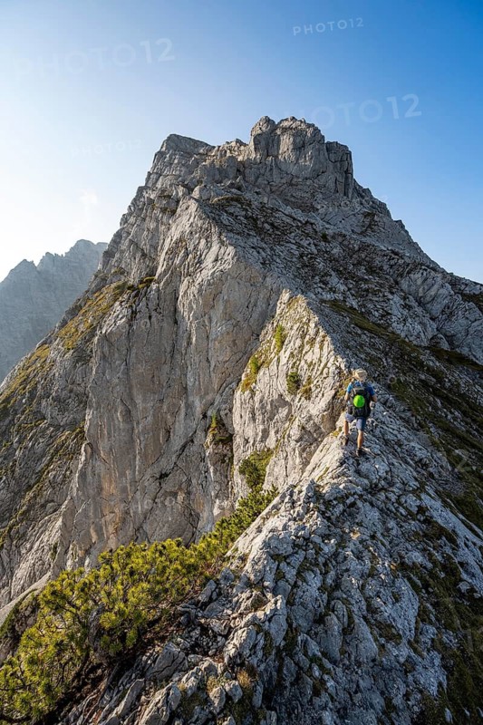 Mountaineer on a narrow ridge, mountain tour to the summit of the Hochkalter, Hochkalter crossing, Berchtesgaden Alps, Bavaria, Germany