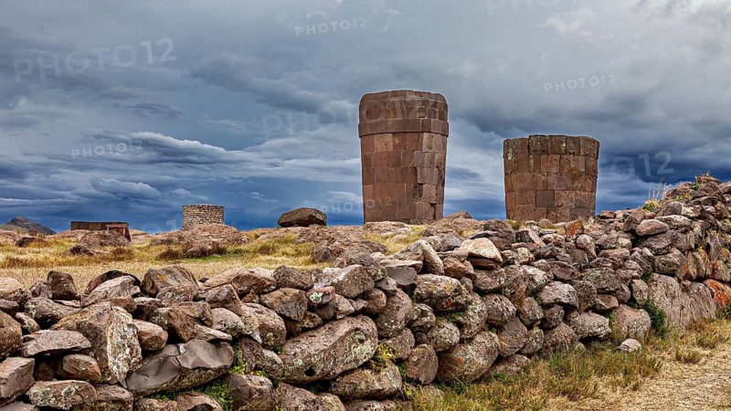 Dramatic clouds over old stone towers and walls, The Chullpas of Sillustani near Puno in Peru