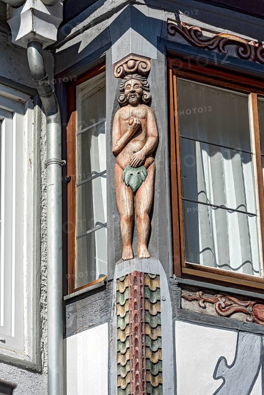 Biblical figure of Adam with apple and fig leaf, colourfully painted carving on the bay window of the Duchscherer Haus, historic half-timbered house of the early Baroque, decor, colourful, old town, Hadamar, Limburg-Weilburg, Westerwald, Hesse, Germany