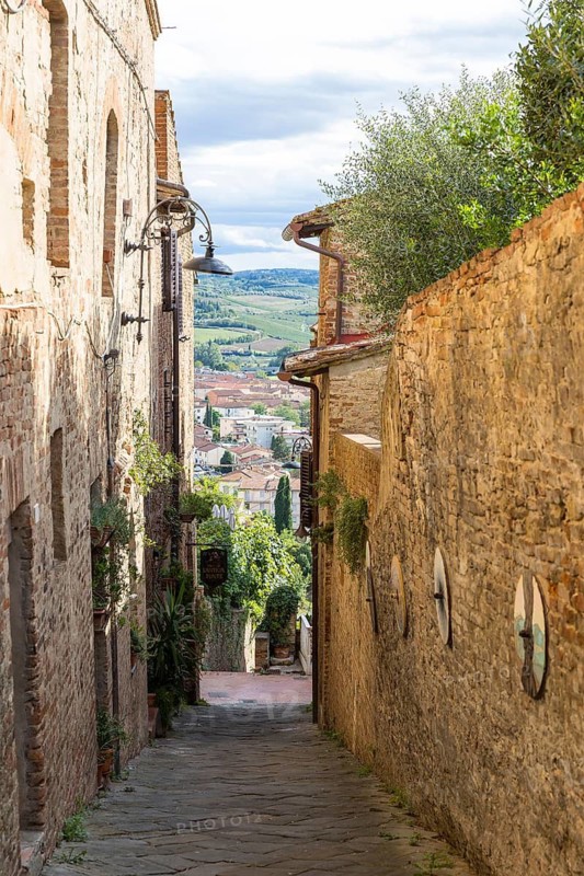 Narrow alleyways with views of the surrounding hills, old town centre of Certaldo, Tuscany, Italy