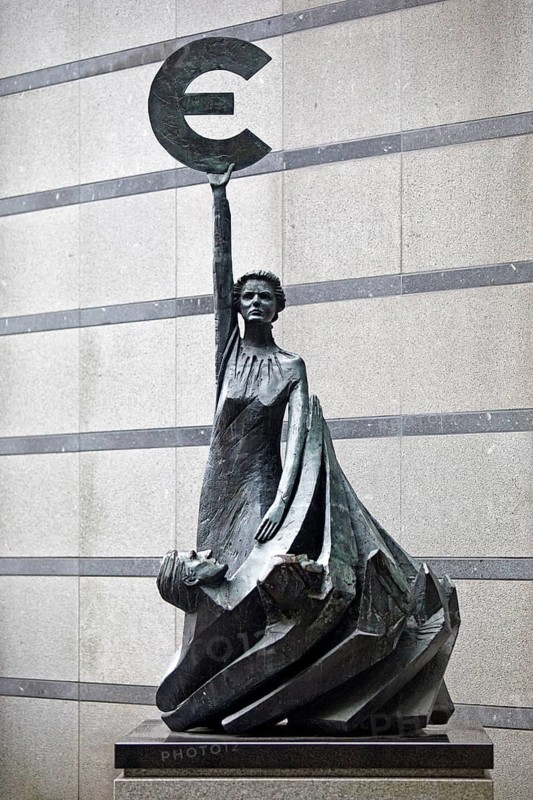 The bronze statue entitled Europe by May Claerhout holds up the euro symbol, Rue Wiertz, European Parliament, Brussels