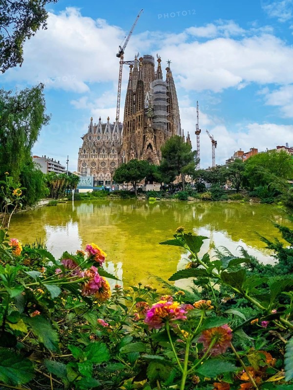Basilica of the Sagrada Familia in Barcelona by the lake without people, Spain
