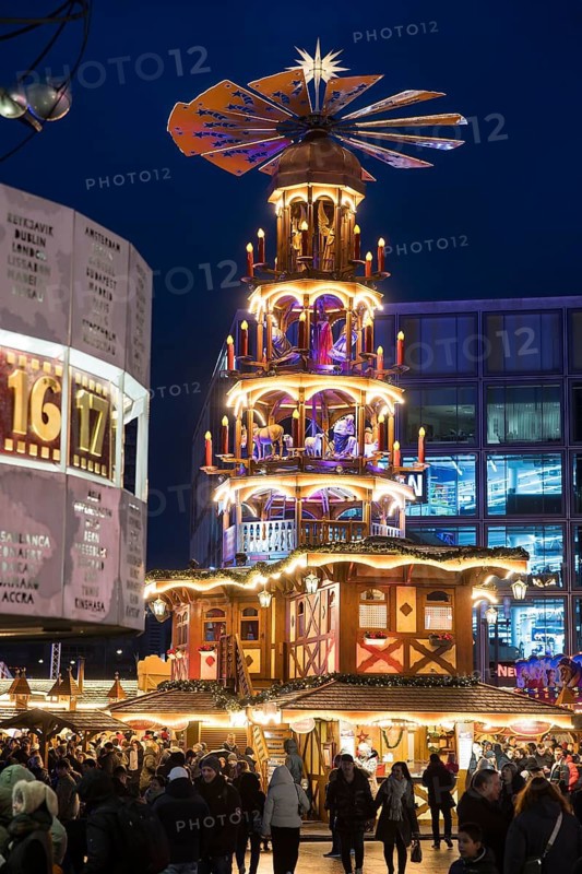 A Christmas pyramid behind the World Time Clock at the Christmas market on Alexanderplatz, Berlin, 21.12.2024