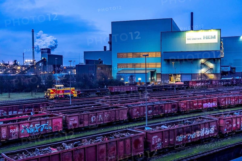 Hüttenwerke Krupp-Mannesmann, HKM in Duisburg, houses of the blast steel plant, coking plant, extinguishing tower with fire cloud, marshalling yard tracks, freight wagon with scrap metal, for melting down, North Rhine-Westphalia, Germany