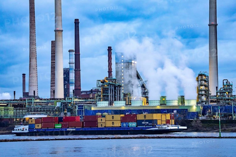 Shipping traffic on the Rhine near Duisburg-Bruckhausen, industrial setting of the ThyssenKrupp steel plant, Schwelgern coking plant, North Rhine-Westphalia, Germany