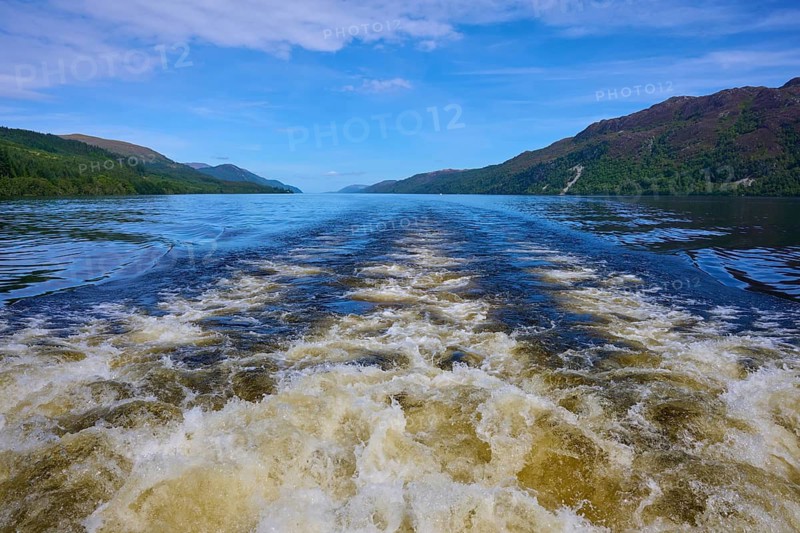 View of a lake with waves and surrounding mountains under clear sky, Fort Augustus, Loch Ness, Scotland, United Kingdom, Great Britain