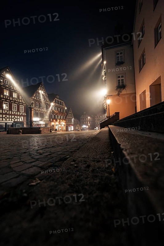 Night-time street scene with half-timbered houses and cobblestones, quietly and atmospherically illuminated, Calw, Black Forest, Germany