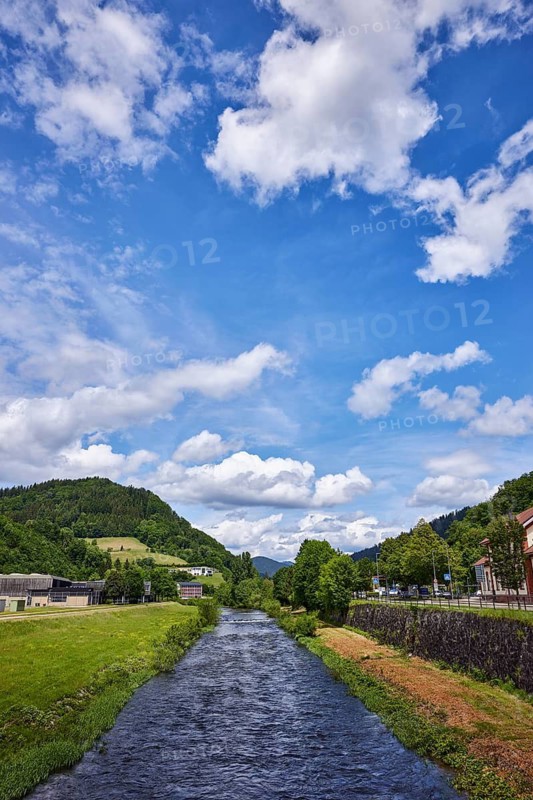River Kinzig, meadow, trees, hilly landscape with coniferous forest, deep blue sky with cumulus clouds, Bahnhofstraße, Wolfach, Black Forest, Ortenaukreis, Baden-Württemberg, Germany