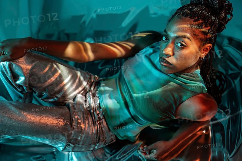 A futuristic African young woman embraces the metaverse, surrounded by vibrant colors and digital elements, symbolizing the intersection of technology and humanity
