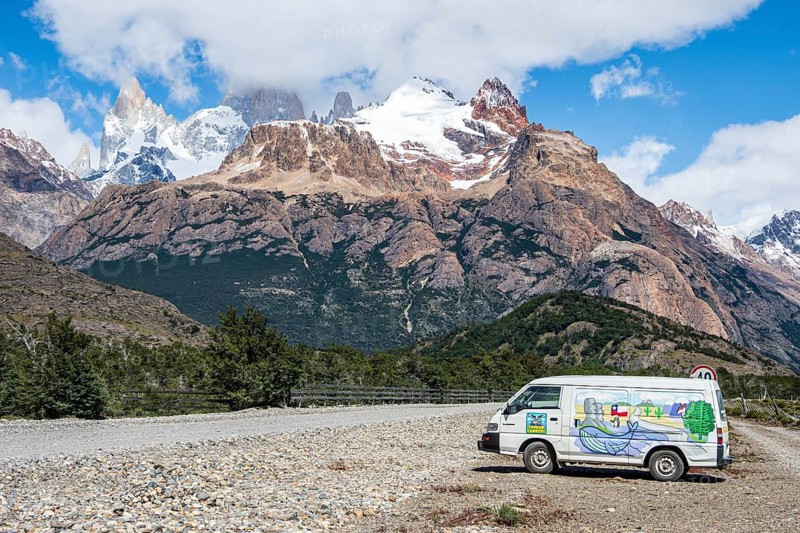 Painted camper van in front of Cerro Torre mountain range, road El Chalten - Lago del desierto, Argentina