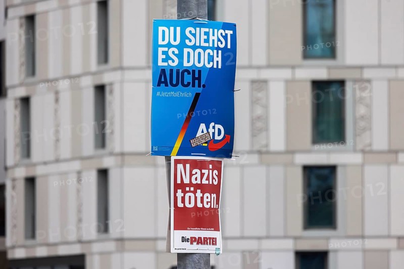 2026 state election in Baden-Württemberg. Election advertising in the city center of Stuttgart. Poster of the AfD party. Including a poster from THE PARTY THE PARTY with the slogan: Kill Nazis. Liver: Racist crap. Stuttgart, Baden-Württemberg, Germany