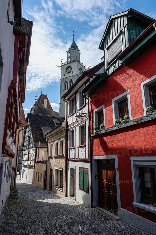The Luziengasse with lined half-timbered houses and the bell tower of Überlinger Münster in the historic old town of Überlingen am Lake Constance, Bodenseekreis, Baden-Württemberg, Germany