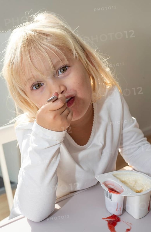 Portrait of blonde girl, 3 years old, having lunch in Ystad, Skåne County, Sweden, Scandinavia