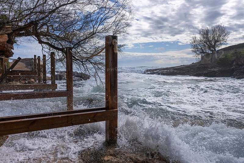Wooden walkway destroyed by the sea, east coast in Cala Ratjada, Majorca, Spain