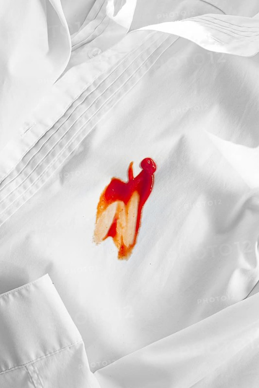White shirt stained with ketchup, no people, close-up, selective focus