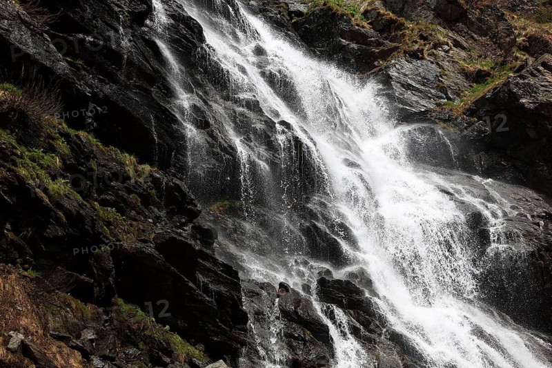 Torrent on the Transfogarasan Highway, Transfagarasan, connects the Arges Valley in Great Wallachia with the Olt Valley in Transylvania, crossing the Fagaras Mountains in the Transylvania Alps, to melt snow in May, Romania