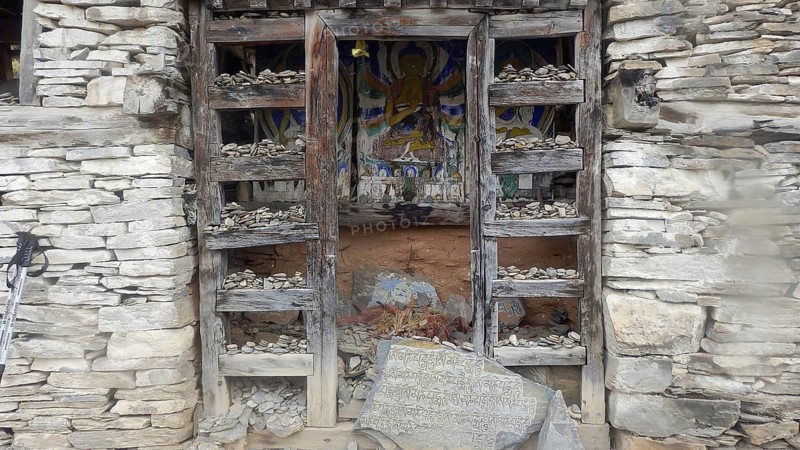 Buddhist stone shrine with religious motif, trekking at Annapurna Circuit, Manang, Nepal